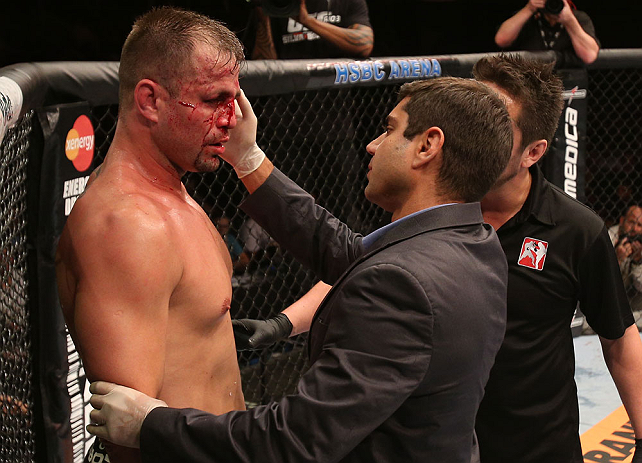 RIO DE JANEIRO, BRAZIL - OCTOBER 13:  A doctor examines Fabio Maldonado (L) during his light heavyweight fight against Glover Teixeira at UFC 153 inside HSBC Arena on October 13, 2012 in Rio de Janeiro, Brazil.  (Photo by Josh Hedges/Zuffa LLC/Zuffa LLC via Getty Images)