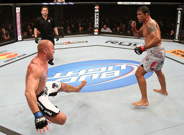RIO DE JANEIRO, BRAZIL - OCTOBER 13:  (R-L) Antonio Rodrigo "Minotauro" Nogeuira knocks down Dave Herman with a punch during their heavyweight fight at UFC 153 inside HSBC Arena on October 13, 2012 in Rio de Janeiro, Brazil.  (Photo by Josh Hedges/Zuffa LLC/Zuffa LLC via Getty Images)