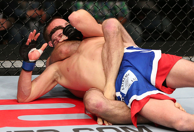 MINNEAPOLIS, MN - OCTOBER 05: (R-L) Jacob Volkmann secures a rear choke submission against Shane Roller during their lightweight fight at the UFC on FX event at Target Center on October 5, 2012 in Minneapolis, Minnesota. (Photo by Josh Hedges/Zuffa LLC/Zuffa LLC via Getty Images)