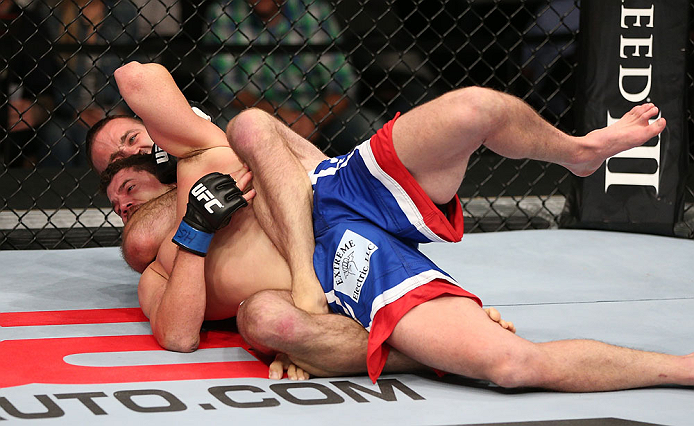 MINNEAPOLIS, MN - OCTOBER 05: (R-L) Jacob Volkmann secures a rear choke submission against Shane Roller during their lightweight fight at the UFC on FX event at Target Center on October 5, 2012 in Minneapolis, Minnesota. (Photo by Josh Hedges/Zuffa LLC/Zuffa LLC via Getty Images)