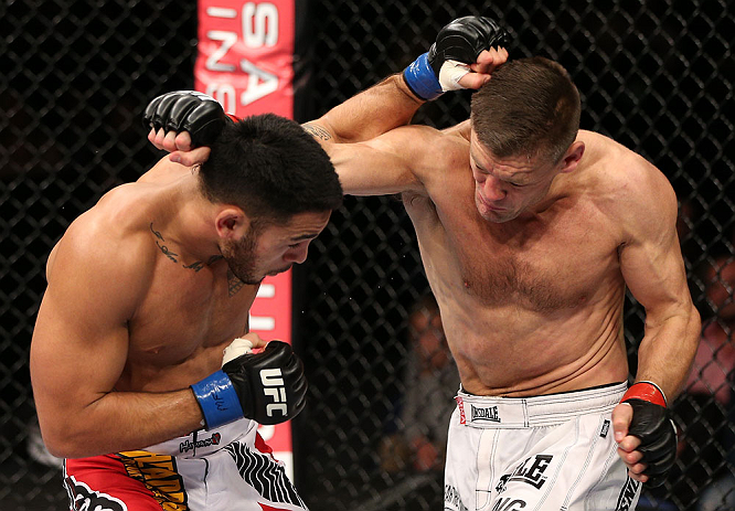 NOTTINGHAM, ENGLAND - SEPTEMBER 29: (R-L) Tom Watson and Brad Tavares trade punches during their middleweight fight at the UFC on Fuel TV event at Capital FM Arena on September 29, 2012 in Nottingham, England. (Photo by Josh Hedges/Zuffa LLC/Zuffa LLC via Getty Images)