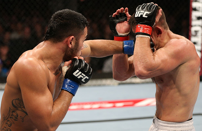 NOTTINGHAM, ENGLAND - SEPTEMBER 29: (L-R) Brad Tavares punches Tom Watson during their middleweight fight at the UFC on Fuel TV event at Capital FM Arena on September 29, 2012 in Nottingham, England. (Photo by Josh Hedges/Zuffa LLC/Zuffa LLC via Getty Images)