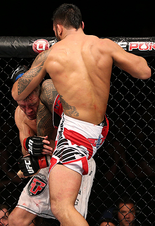 NOTTINGHAM, ENGLAND - SEPTEMBER 29: (R-L) Brad Tavares delivers a flying knee against Tom Watson during their middleweight fight at the UFC on Fuel TV event at Capital FM Arena on September 29, 2012 in Nottingham, England. (Photo by Josh Hedges/Zuffa LLC/Zuffa LLC via Getty Images)