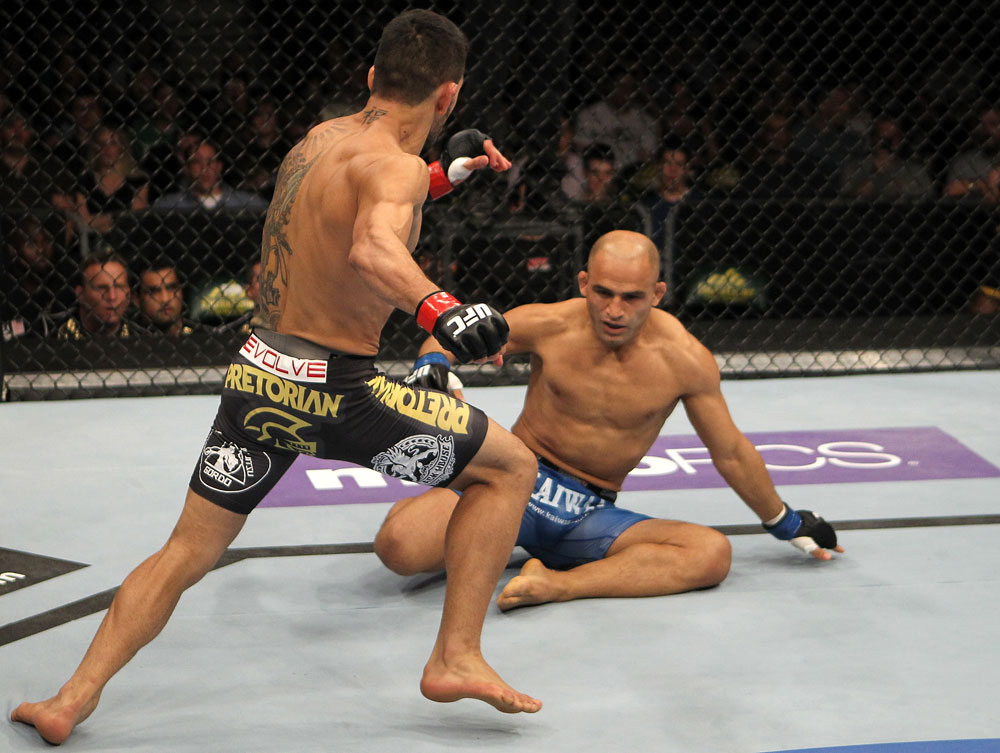 FAIRFAX, VA - MAY 15:  (L-R) Rafael Dos Anjos rushes in to finish Kamal Shalorus after knocking him down with a kick in a lightweight bout during the UFC on Fuel TV event at Patriot Center on May 15, 2012 in Fairfax, Virginia.  (Photo by Josh Hedges/Zuffa LLC/Zuffa LLC via Getty Images)