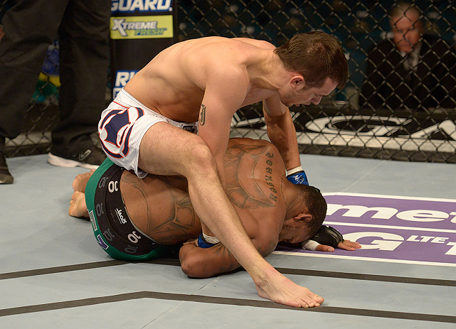 LAS VEGAS, NV - DECEMBER 29:  Myles Jury (top) punches Michael Johnson during their lightweight fight at UFC 155 on December 29, 2012 at MGM Grand Garden Arena in Las Vegas, Nevada. (Photo by Donald Miralle/Zuffa LLC/Zuffa LLC via Getty Images) *** Local Caption *** Michael Johnson; Myles Jury