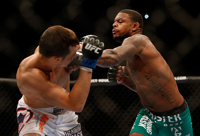 LAS VEGAS, NV - DECEMBER 29:  (R-L) Michael Johnson punches Myles Jury during their lightweight fight at UFC 155 on December 29, 2012 at MGM Grand Garden Arena in Las Vegas, Nevada. (Photo by Josh Hedges/Zuffa LLC/Zuffa LLC via Getty Images) *** Local Caption *** Michael Johnson; Myles Jury