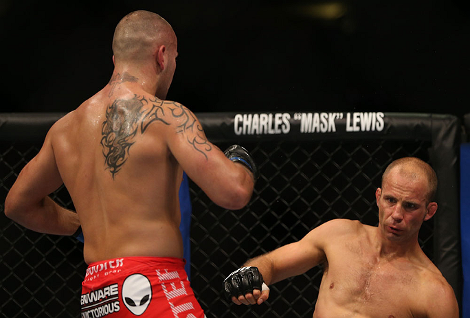 DENVER, CO - AUGUST 11: (L-R) Michael Kuiper knocks down Jared Hamman with a punch during their middleweight bout at UFC 150 inside Pepsi Center on August 11, 2012 in Denver, Colorado. (Photo by Josh Hedges/Zuffa LLC/Zuffa LLC via Getty Images)