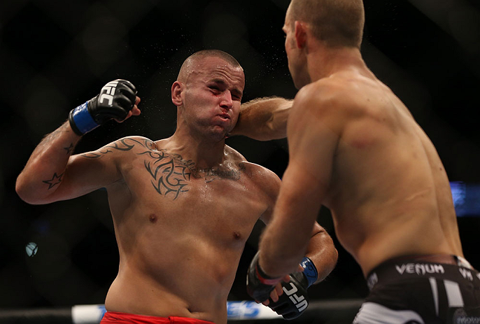 DENVER, CO - AUGUST 11: (R-L) Jared Hamman punches Michael Kuiper during their middleweight bout at UFC 150 inside Pepsi Center on August 11, 2012 in Denver, Colorado. (Photo by Josh Hedges/Zuffa LLC/Zuffa LLC via Getty Images)