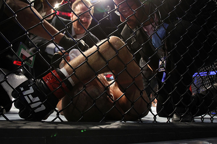 DENVER, CO - AUGUST 11: Jared Hamman lies on the canvas after being knocked out by Michael Kuiper during their middleweight bout at UFC 150 inside Pepsi Center on August 11, 2012 in Denver, Colorado. (Photo by Josh Hedges/Zuffa LLC/Zuffa LLC via Getty Images)