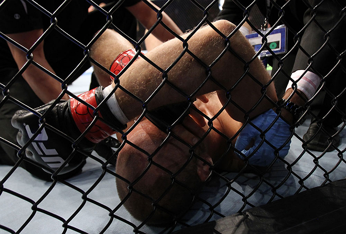 DENVER, CO - AUGUST 11: Jared Hamman lies on the canvas after being knocked out by Michael Kuiper during their middleweight bout at UFC 150 inside Pepsi Center on August 11, 2012 in Denver, Colorado. (Photo by Josh Hedges/Zuffa LLC/Zuffa LLC via Getty Images)