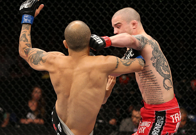 NOTTINGHAM, ENGLAND - SEPTEMBER 29: (R-L) Andy Ogle punches Akira Corassani during their featherweight fight at the UFC on Fuel TV event at Capital FM Arena on September 29, 2012 in Nottingham, England. (Photo by Josh Hedges/Zuffa LLC/Zuffa LLC via Getty Images)