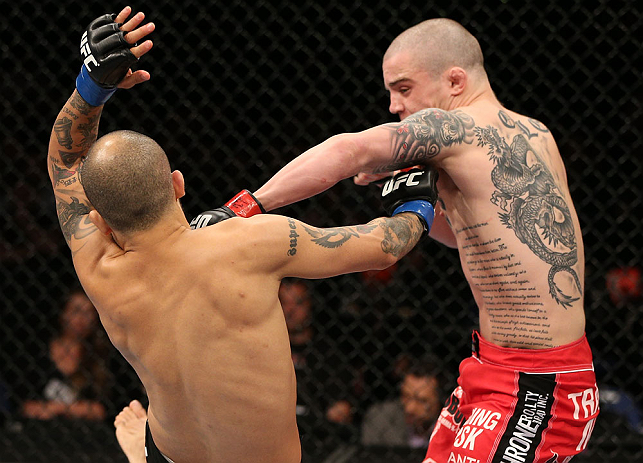 NOTTINGHAM, ENGLAND - SEPTEMBER 29: (R-L) Andy Ogle punches Akira Corassani during their featherweight fight at the UFC on Fuel TV event at Capital FM Arena on September 29, 2012 in Nottingham, England. (Photo by Josh Hedges/Zuffa LLC/Zuffa LLC via Getty Images)