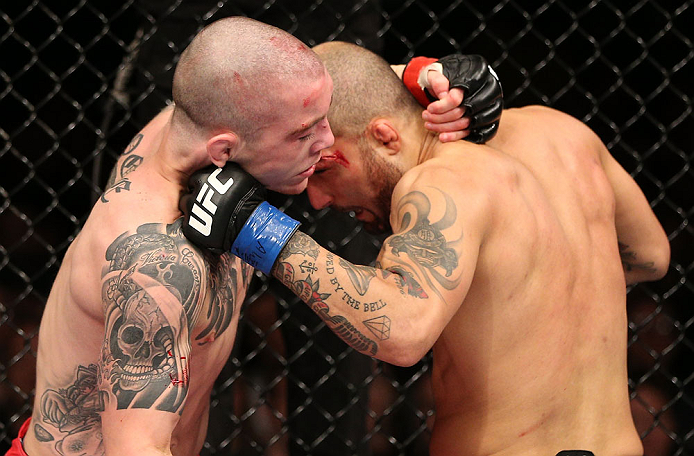 NOTTINGHAM, ENGLAND - SEPTEMBER 29: (R-L) Akira Corassani punches Andy Ogle during their featherweight fight at the UFC on Fuel TV event at Capital FM Arena on September 29, 2012 in Nottingham, England. (Photo by Josh Hedges/Zuffa LLC/Zuffa LLC via Getty Images)