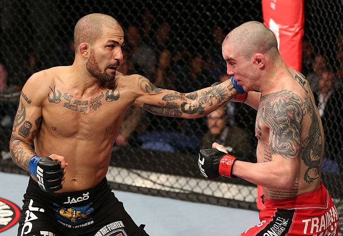 NOTTINGHAM, ENGLAND - SEPTEMBER 29: (L-R) Akira Corassani punches Andy Ogle during their featherweight fight at the UFC on Fuel TV event at Capital FM Arena on September 29, 2012 in Nottingham, England. (Photo by Josh Hedges/Zuffa LLC/Zuffa LLC via Getty Images)