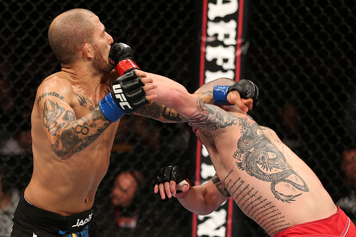 NOTTINGHAM, ENGLAND - SEPTEMBER 29: (R-L) Andy Ogle punches Akira Corassani during their featherweight fight at the UFC on Fuel TV event at Capital FM Arena on September 29, 2012 in Nottingham, England. (Photo by Josh Hedges/Zuffa LLC/Zuffa LLC via Getty Images)