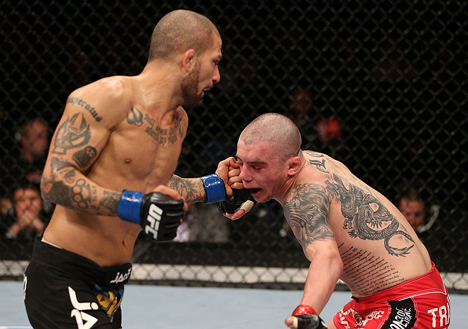 NOTTINGHAM, ENGLAND - SEPTEMBER 29: (L-R) Akira Corassani punches Andy Ogle during their featherweight fight at the UFC on Fuel TV event at Capital FM Arena on September 29, 2012 in Nottingham, England. (Photo by Josh Hedges/Zuffa LLC/Zuffa LLC via Getty Images)