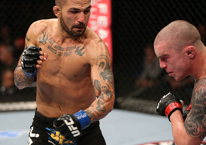 NOTTINGHAM, ENGLAND - SEPTEMBER 29: (L-R) Akira Corassani punches Andy Ogle during their featherweight fight at the UFC on Fuel TV event at Capital FM Arena on September 29, 2012 in Nottingham, England. (Photo by Josh Hedges/Zuffa LLC/Zuffa LLC via Getty Images)