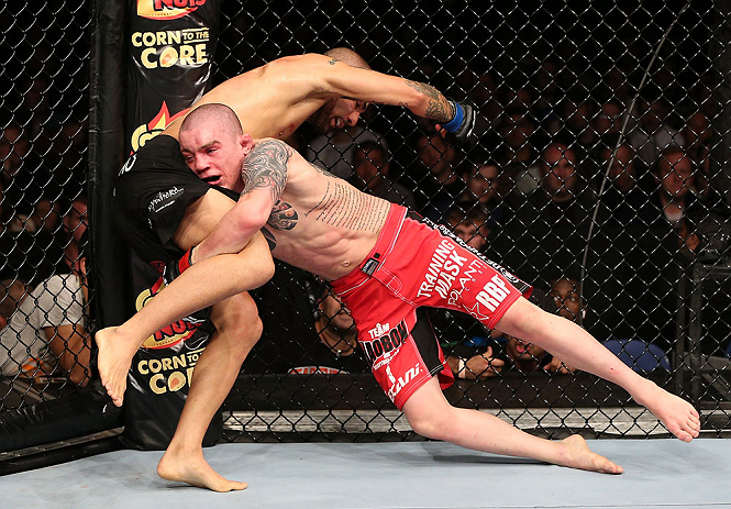 NOTTINGHAM, ENGLAND - SEPTEMBER 29: (R-L) Andy Ogle takes down Akira Corassani during their featherweight fight at the UFC on Fuel TV event at Capital FM Arena on September 29, 2012 in Nottingham, England. (Photo by Josh Hedges/Zuffa LLC/Zuffa LLC via Getty Images)