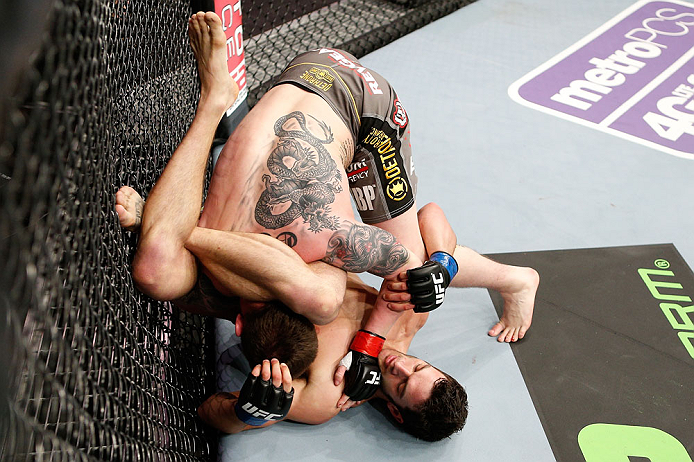 LONDON, ENGLAND - FEBRUARY 16: (R-L) Josh Grispi attempts a triangle choke against Andy Ogle in their featherweight fight during the UFC on Fuel TV event on February 16, 2013 at Wembley Arena in London, England. (Photo by Josh Hedges/Zuffa LLC/Zuffa LLC via Getty Images)
