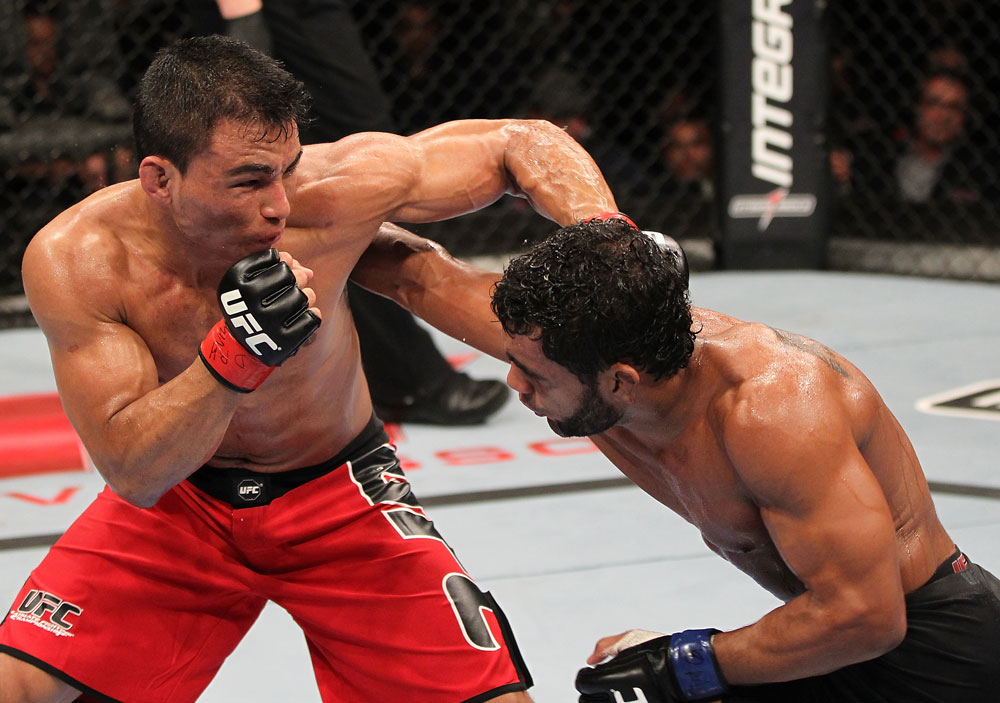 BELO HORIZONTE, BRAZIL - JUNE 23: (L-R) John Teixeira and Hugo "Wolverine" Viana trade punches during their UFC 147 featherweight bout at Estadio Jornalista Felipe Drummond on June 23, 2012 in Belo Horizonte, Brazil. (Photo by Josh Hedges/Zuffa LLC/Zuffa LLC via Getty Images)