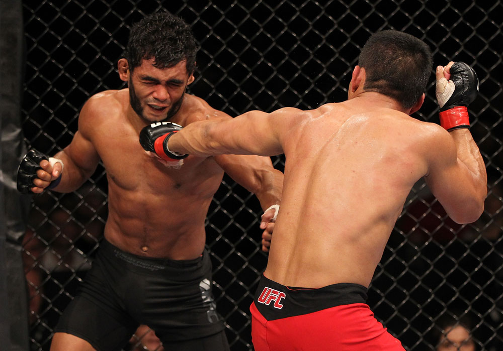 BELO HORIZONTE, BRAZIL - JUNE 23: (R-L) John Teixeira punches Hugo "Wolverine" Viana during their UFC 147 featherweight bout at Estadio Jornalista Felipe Drummond on June 23, 2012 in Belo Horizonte, Brazil. (Photo by Josh Hedges/Zuffa LLC/Zuffa LLC via Getty Images)