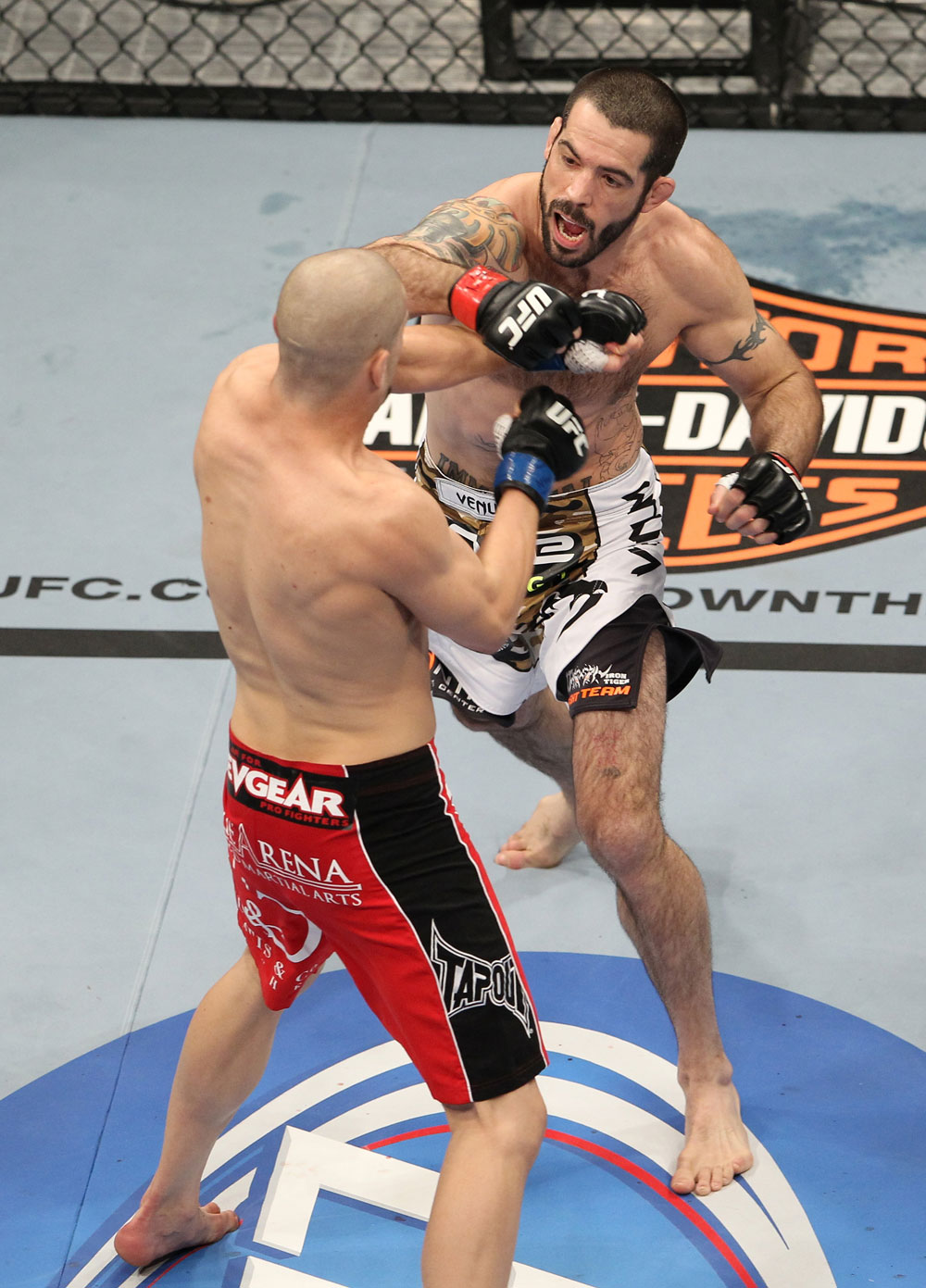 LAS VEGAS, NV - FEBRUARY 04:  Matt Brown (white shorts) and Chris Cope (red/black shorts) exchange punches during the UFC 143 event at Mandalay Bay Events Center on February 4, 2012 in Las Vegas, Nevada.  (Photo by Josh Hedges/Zuffa LLC/Zuffa LLC via Getty Images) *** Local Caption *** Matt Brown; Chris Cope