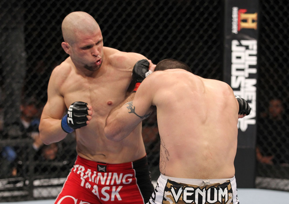 LAS VEGAS, NV - FEBRUARY 04:  Chris Cope (red shorts) punches Matt Brown during the UFC 143 event at Mandalay Bay Events Center on February 4, 2012 in Las Vegas, Nevada.  (Photo by Nick Laham/Zuffa LLC/Zuffa LLC via Getty Images) *** Local Caption *** Chris Cope