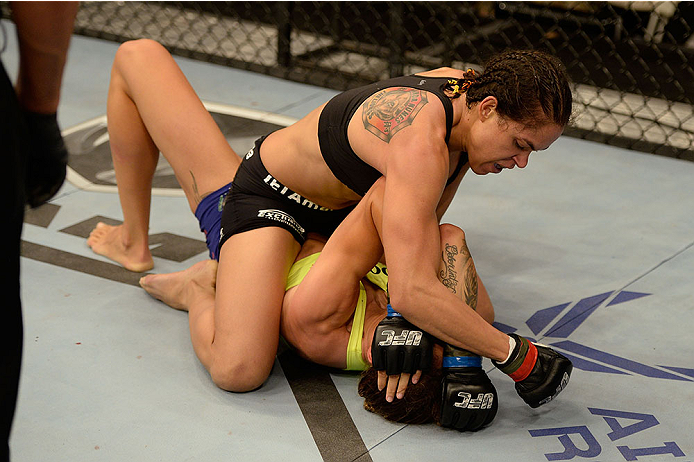 Amanda Nunes (top) punches Germaine de Randamie in their UFC women's bantamweight bout on November 6, 2013 in Fort Campbell, KY. (Photo by Jeff Bottari/Zuffa LLC)