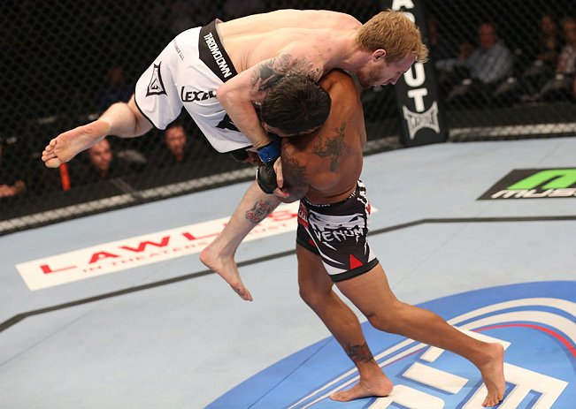 DENVER, CO - AUGUST 11:  (R-L) Dennis Bermudez takes down Tommy Hayden during their featherweight bout at UFC 150 inside Pepsi Center on August 11, 2012 in Denver, Colorado. (Photo by Nick Laham/Zuffa LLC/Zuffa LLC via Getty Images)