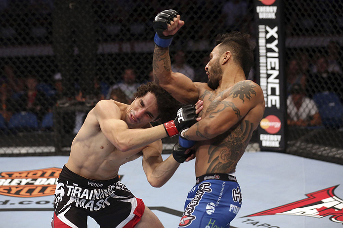 CALGARY, CANADA - JULY 21:  (R-L) Francisco Rivera lands a punch to the head of Roland Delorme during their bantamweight bout at UFC 149 inside the Scotiabank Saddledome on July 21, 2012 in Calgary, Alberta, Canada.  (Photo by Nick Laham/Zuffa LLC/Zuffa LLC via Getty Images)