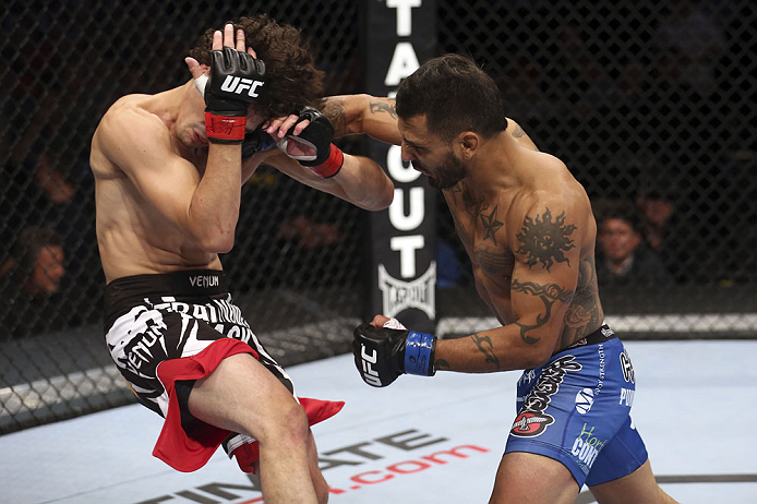 CALGARY, CANADA - JULY 21:  (R-L) Francisco Rivera lands a punch to the head of Roland Delorme during their bantamweight bout at UFC 149 inside the Scotiabank Saddledome on July 21, 2012 in Calgary, Alberta, Canada.  (Photo by Nick Laham/Zuffa LLC/Zuffa LLC via Getty Images)