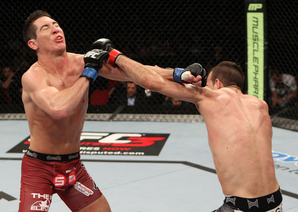 SYDNEY, AUSTRALIA - MARCH 03: (R-L) Cole Miller punches Steven Siler in a featherweight bout during the UFC on FX event at Allphones Arena on March 3, 2012 in Sydney, Australia. (Photo by Josh Hedges/Zuffa LLC/Zuffa LLC via Getty Images) *** Local Caption *** Cole Miller; Steven Siler
