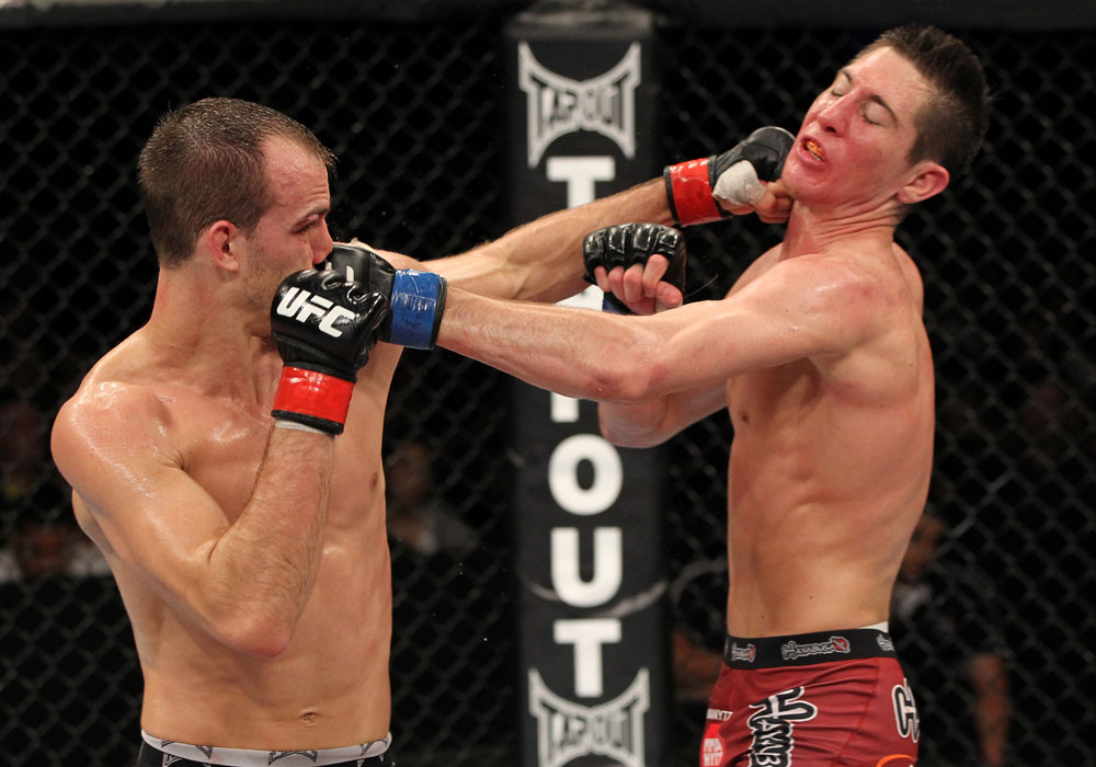 SYDNEY, AUSTRALIA - MARCH 03: (R-L) Steven Siler and Cole Miller trade punches in a featherweight bout during the UFC on FX event at Allphones Arena on March 3, 2012 in Sydney, Australia. (Photo by Josh Hedges/Zuffa LLC/Zuffa LLC via Getty Images) *** Local Caption *** Cole Miller; Steven Siler