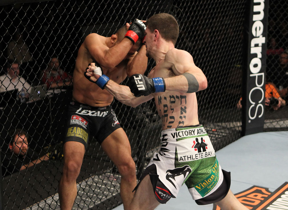 OMAHA, NE - FEBRUARY 15: (R-L) John Albert punches Ivan Menjivar during the UFC on FUEL TV event at Omaha Civic Auditorium on February 15, 2012 in Omaha, Nebraska. (Photo by Josh Hedges/Zuffa LLC/Zuffa LLC via Getty Images) *** Local Caption *** Ivan Menjivar; John Albert