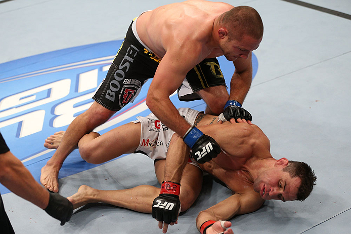 MINNEAPOLIS, MN - OCTOBER 05: (L-R) Mike Pierce knocks out Aaron Simpson with a series of punches during their welterweight fight at the UFC on FX event at Target Center on October 5, 2012 in Minneapolis, Minnesota. (Photo by Josh Hedges/Zuffa LLC/Zuffa LLC via Getty Images)