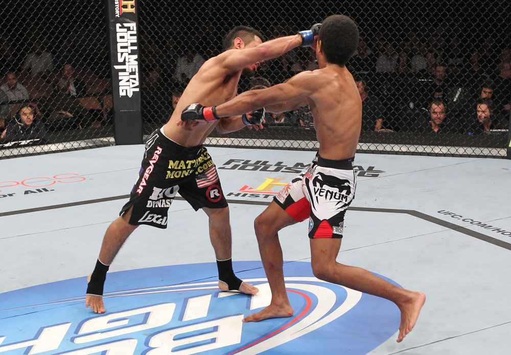 LAS VEGAS, NV - FEBRUARY 04:  Edwin Figueroa (left) punches Alex Caceres during the UFC 143 event at Mandalay Bay Events Center on February 4, 2012 in Las Vegas, Nevada.  (Photo by Nick Laham/Zuffa LLC/Zuffa LLC via Getty Images) *** Local Caption *** Edwin Figueroa; Alex Caceres