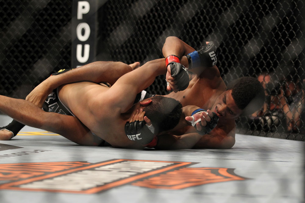 LAS VEGAS, NV - FEBRUARY 04:  Alex Caceres (right) throws punches at Edwin Figueroa on the ground during the UFC 143 event at Mandalay Bay Events Center on February 4, 2012 in Las Vegas, Nevada.  (Photo by Josh Hedges/Zuffa LLC/Zuffa LLC via Getty Images) *** Local Caption *** Alex Caceres; Edwin Figueroa