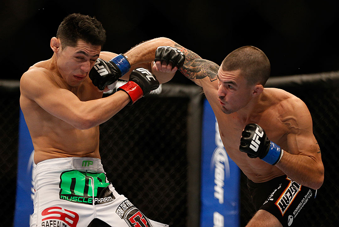 LAS VEGAS, NV - DECEMBER 29:  Byron Bloodworth (right) punches Erik Perez during their bantamweight fight at UFC 155 on December 29, 2012 at MGM Grand Garden Arena in Las Vegas, Nevada. (Photo by Josh Hedges/Zuffa LLC/Zuffa LLC via Getty Images) *** Local Caption *** Erik Perez; Byron Bloodworth