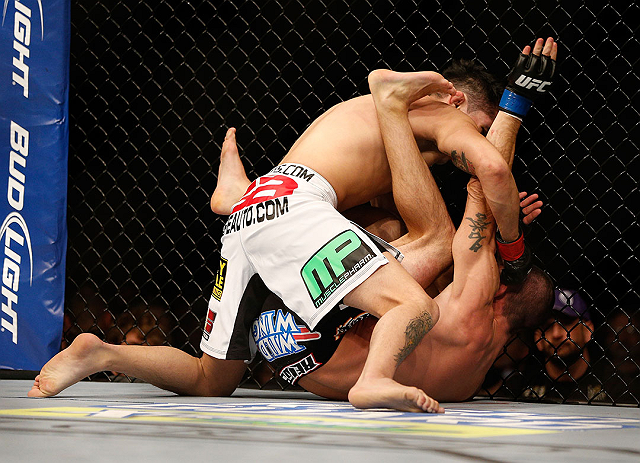 LAS VEGAS, NV - DECEMBER 29:  Erik Perez (white shorts) punches Byron Bloodworth during their bantamweight fight at UFC 155 on December 29, 2012 at MGM Grand Garden Arena in Las Vegas, Nevada. (Photo by Josh Hedges/Zuffa LLC/Zuffa LLC via Getty Images) *** Local Caption *** Erik Perez; Byron Bloodworth