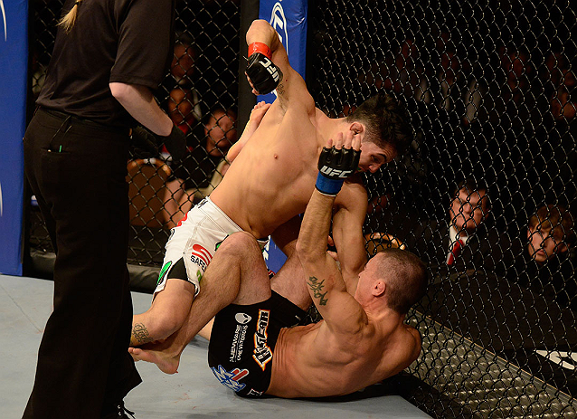 LAS VEGAS, NV - DECEMBER 29:  Erik Perez (top) punches Byron Bloodworth during their bantamweight fight at UFC 155 on December 29, 2012 at MGM Grand Garden Arena in Las Vegas, Nevada. (Photo by Donald Miralle/Zuffa LLC/Zuffa LLC via Getty Images) *** Local Caption *** Erik Perez; Byron Bloodworth