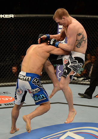 LAS VEGAS, NV - FEBRUARY 02: (R-L) Evan Dunham knees Gleison Tibau during their lightweight fight at UFC 156 on February 2, 2013 at the Mandalay Bay Events Center in Las Vegas, Nevada. (Photo by Donald Miralle/Zuffa LLC/Zuffa LLC via Getty Images) *** Local Caption *** Gleison Tibau; Evan Dunham