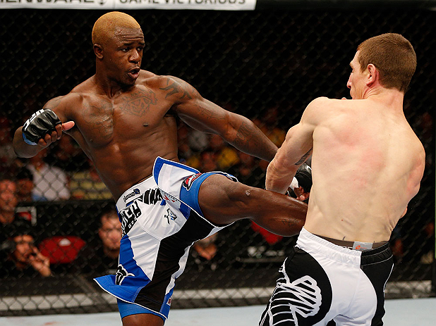 Danzig attempts to block a Guillard body kick Danzig attempts to block a Guillard body kick