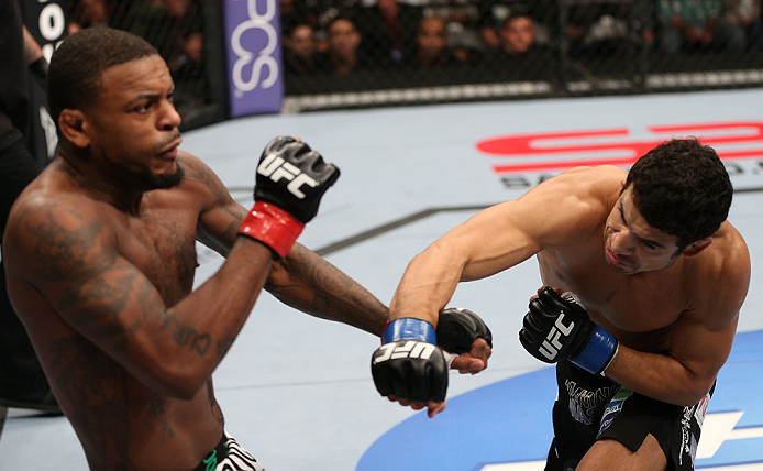 MINNEAPOLIS, MN - OCTOBER 05: (R-L) Danny Castillo knocks down Michael Johnson with a punch during their lightweight fight at the UFC on FX event at Target Center on October 5, 2012 in Minneapolis, Minnesota. (Photo by Josh Hedges/Zuffa LLC/Zuffa LLC via Getty Images)