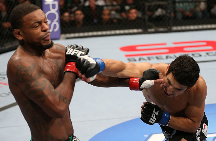 MINNEAPOLIS, MN - OCTOBER 05: (R-L) Danny Castillo knocks down Michael Johnson with a punch during their lightweight fight at the UFC on FX event at Target Center on October 5, 2012 in Minneapolis, Minnesota. (Photo by Josh Hedges/Zuffa LLC/Zuffa LLC via Getty Images)