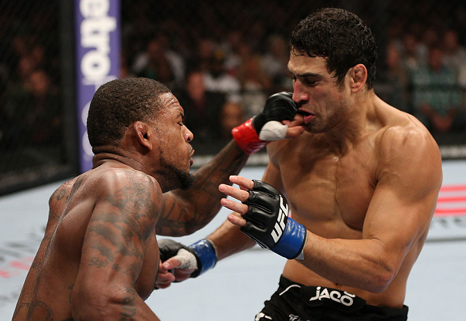 MINNEAPOLIS, MN - OCTOBER 05: (L-R) Michael Johnson knocks out Danny Castillo with a series of punches during their lightweight fight at the UFC on FX event at Target Center on October 5, 2012 in Minneapolis, Minnesota. (Photo by Josh Hedges/Zuffa LLC/Zuffa LLC via Getty Images)