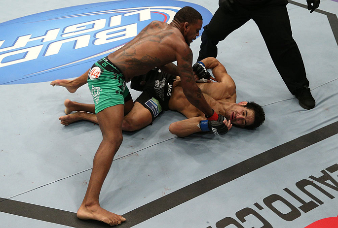 MINNEAPOLIS, MN - OCTOBER 05: (L-R) Michael Johnson knocks out Danny Castillo with a series of punches during their lightweight fight at the UFC on FX event at Target Center on October 5, 2012 in Minneapolis, Minnesota. (Photo by Josh Hedges/Zuffa LLC/Zuffa LLC via Getty Images)