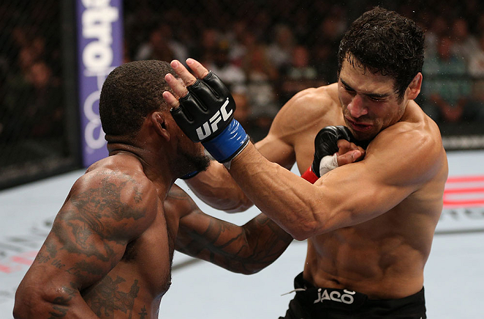 MINNEAPOLIS, MN - OCTOBER 05: (L-R) Michael Johnson knocks out Danny Castillo with a series of punches during their lightweight fight at the UFC on FX event at Target Center on October 5, 2012 in Minneapolis, Minnesota. (Photo by Josh Hedges/Zuffa LLC/Zuffa LLC via Getty Images)
