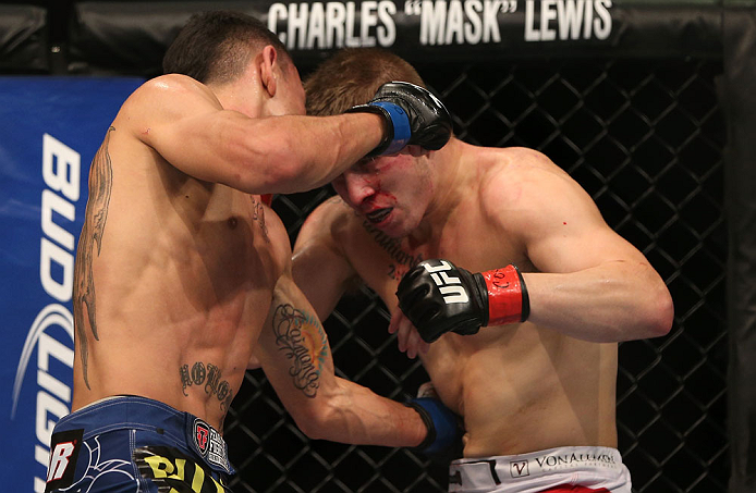 DENVER, CO - AUGUST 11: (L-R) Max Holloway punches Justin Lawrence during their featherweight bout at UFC 150 inside Pepsi Center on August 11, 2012 in Denver, Colorado. (Photo by Josh Hedges/Zuffa LLC/Zuffa LLC via Getty Images)