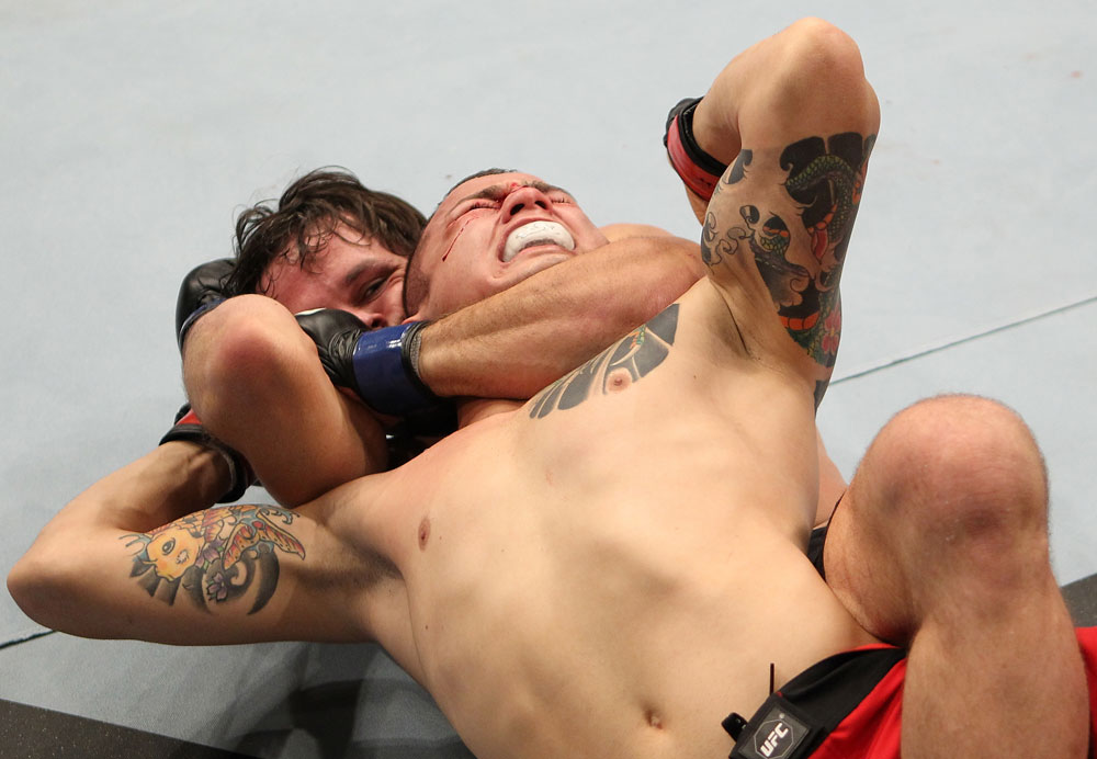 BELO HORIZONTE, BRAZIL - JUNE 23: (L-R) Rodrigo Damm secures a rear choke submission to defeat Anistavio "Gasparzinho" Medeiros during their UFC 147 featherweight bout at Estadio Jornalista Felipe Drummond on June 23, 2012 in Belo Horizonte, Brazil. (Photo by Josh Hedges/Zuffa LLC/Zuffa LLC via Getty Images)