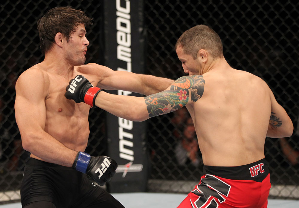 BELO HORIZONTE, BRAZIL - JUNE 23: (L-R) Rodrigo Damm lands a left that drops Anistavio "Gasparzinho" Medeiros during their UFC 147 featherweight bout at Estadio Jornalista Felipe Drummond on June 23, 2012 in Belo Horizonte, Brazil. (Photo by Josh Hedges/Zuffa LLC/Zuffa LLC via Getty Images)
